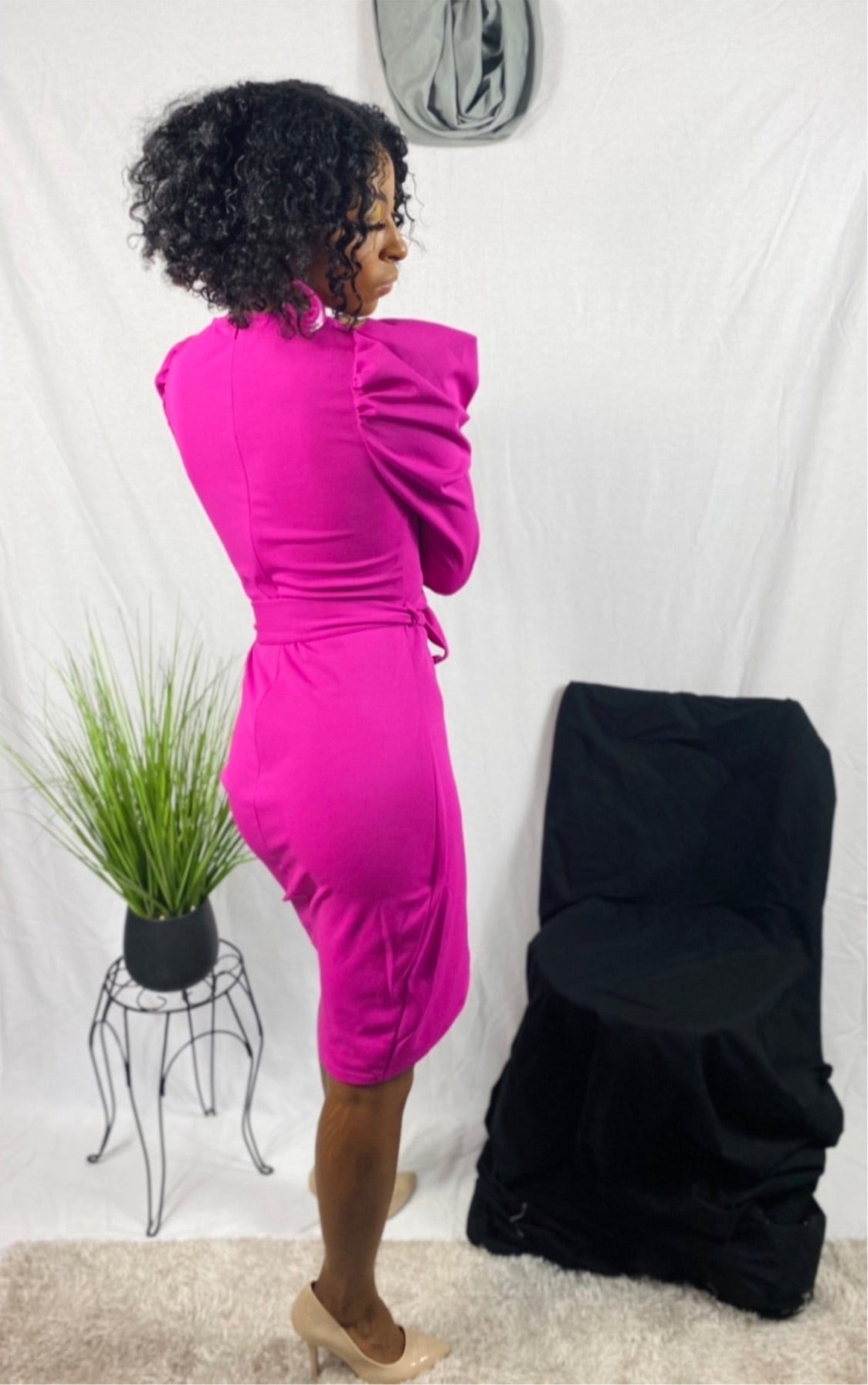 Pink mutton sleeve dress with waist tie and leg slit.